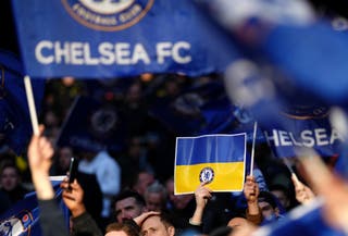 Chelsea fans are seen holding Ukrainian flags before the Carabao Cup final at Wembley Stadium, London (John Walton/PA)